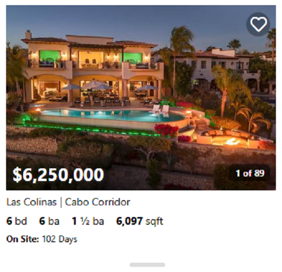 Spanish-style estate in Cabo del Sol featuring terracotta roof, arched windows, and lush gardens
