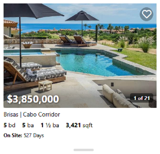 Spanish-style estate in Cabo del Sol featuring terracotta roof, arched windows, and lush gardens.